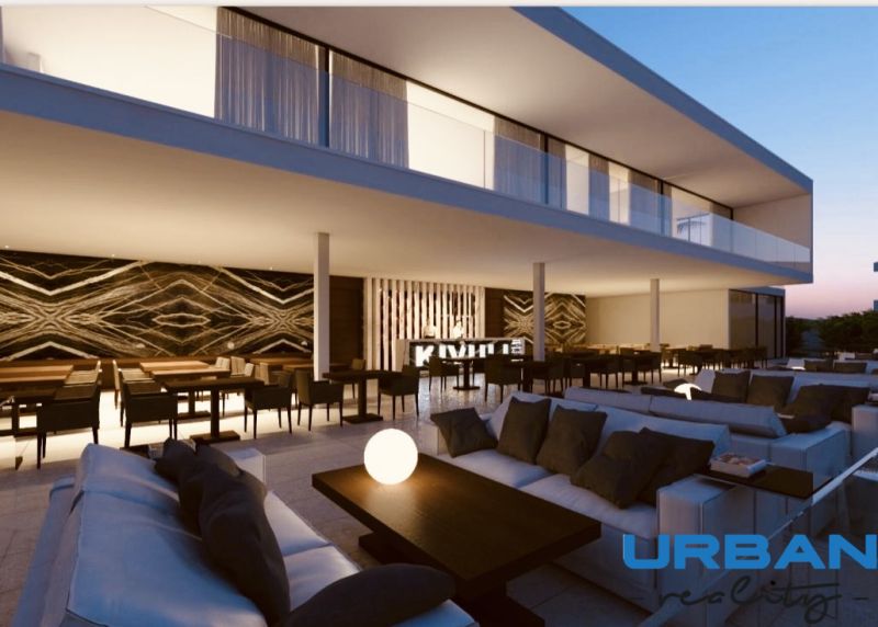 Elegant terrace with comfortable seating and a decorative wall in the restaurant area of commercial properties.