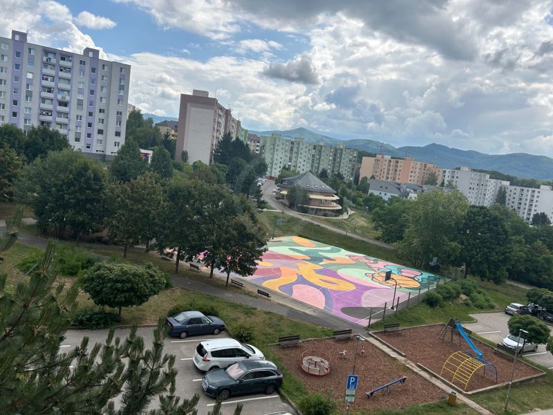 A view of the colorful playground, play area, and apartment buildings on Mateja Bela in Trenčín.
