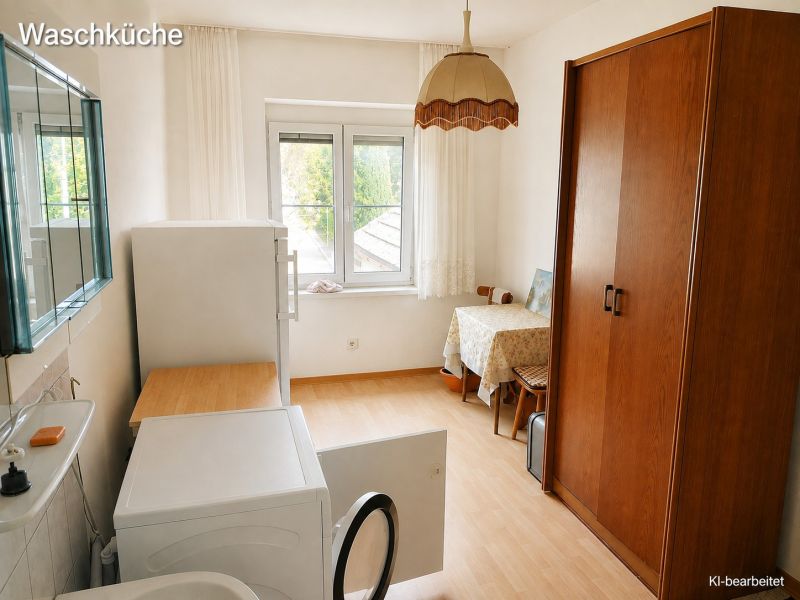 Spacious laundry room in a family house with a wooden decor floor.