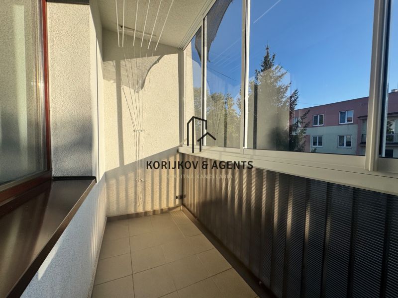 A loggia with glazing and a view of the surroundings in a 4-room apartment.