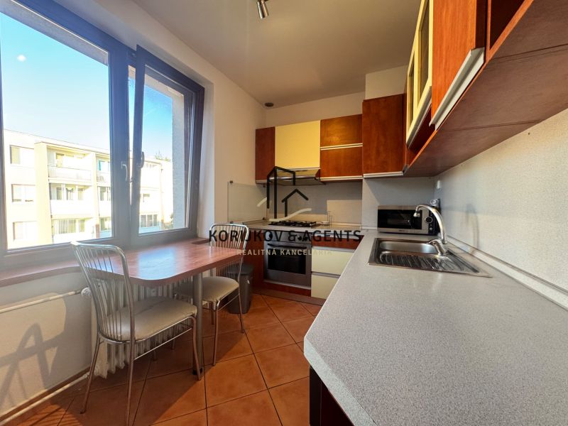 A kitchen in a 4-room apartment with tiles and a kitchenette.