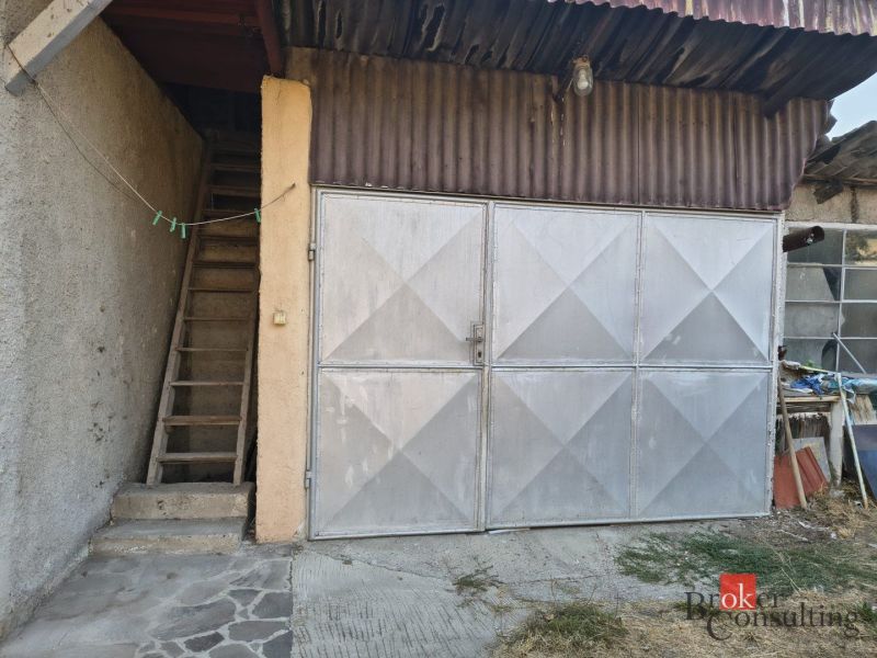 Metal garage door next to the staircase on the property of a family house in Ladice.