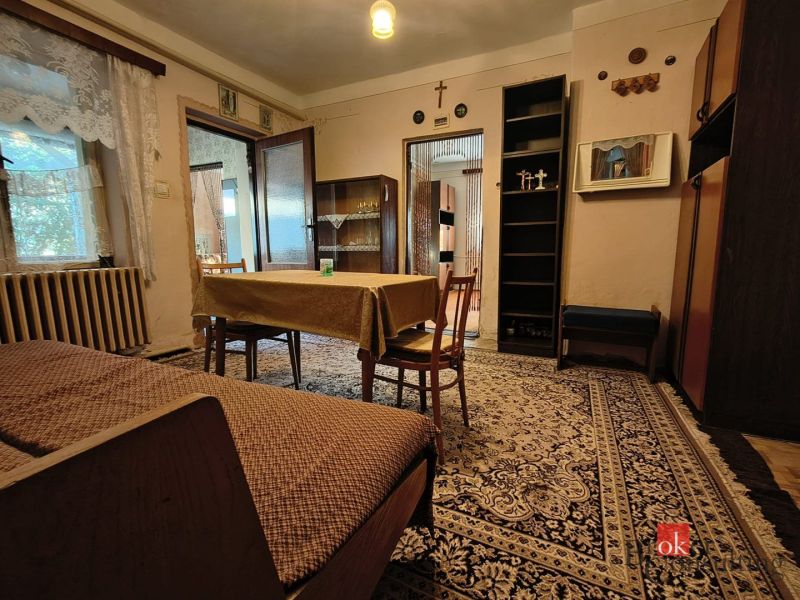Living room with carpets and wooden furniture in a family house.