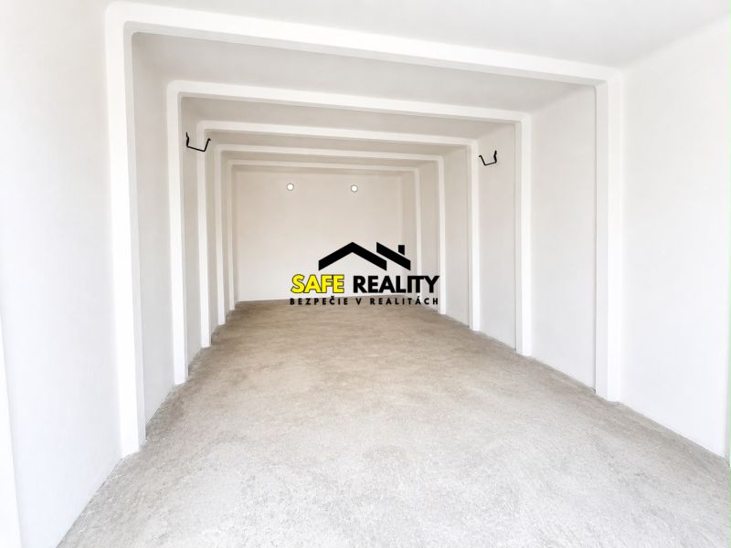 The interior of a spacious garage with white walls and a concrete floor.