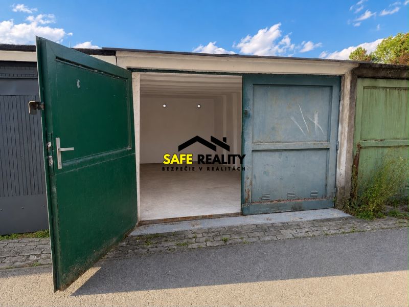 Open garage on Komenského Street in Žilina with a green gate.