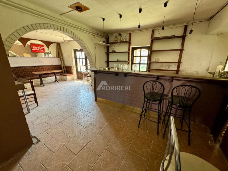 Bar counter and seating in the interior of a family house with tiling.
