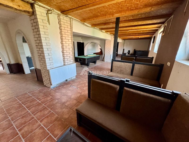 The interior of a family house with a billiard table and brick arches.