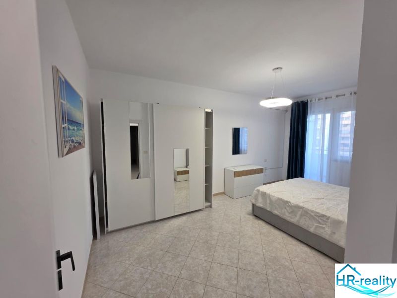Bright bedroom in a 2-room apartment with modern furniture and ceramic flooring.