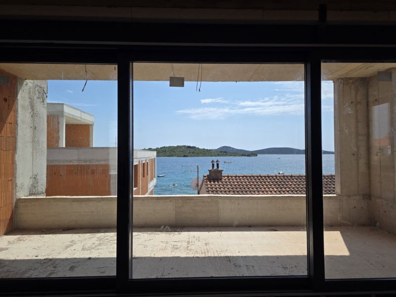 View from a 3-room apartment in SRIMA of the sea through a large French window.