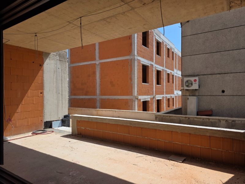 An unfinished 3-room apartment in the town of Srima with a view of brick walls.