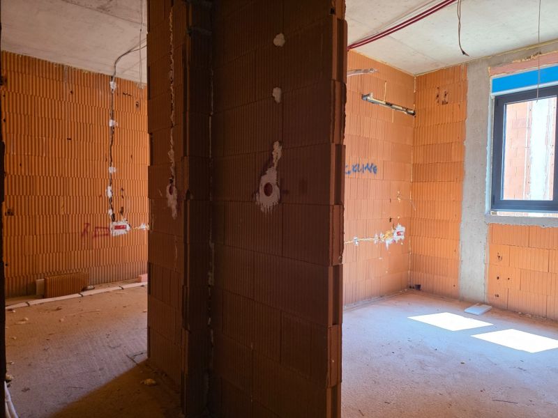 Interior of a 3-room apartment with brick partitions, in the rough construction stage.