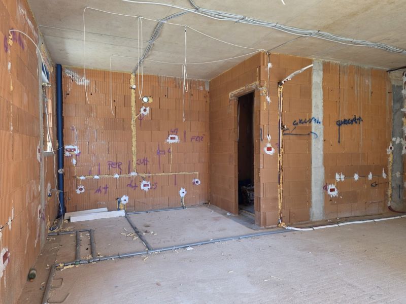 Construction of a 3-room apartment with brick walls and installation of utilities.