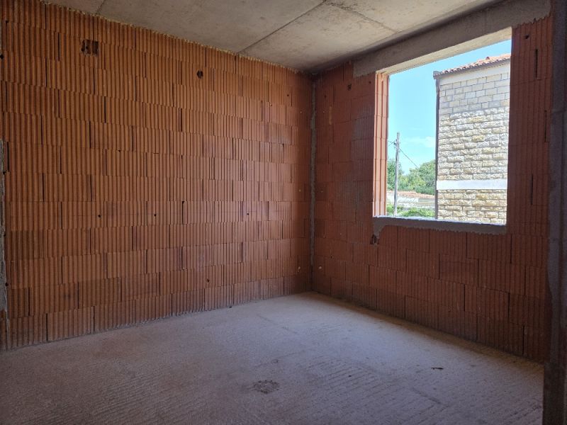Interior construction in a 4-room apartment with brick walls and a concrete floor.