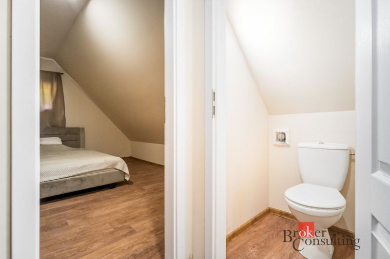 Bedroom and toilet in a cabin with a wooden decor floor.