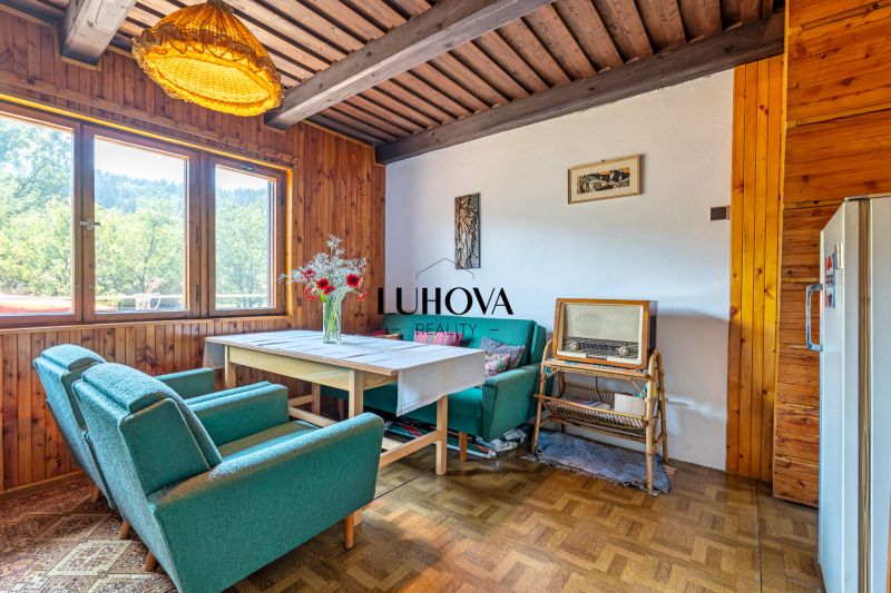 Interior of a cabin with retro furniture and a wooden decor floor, comfortable armchairs, vintage radio.