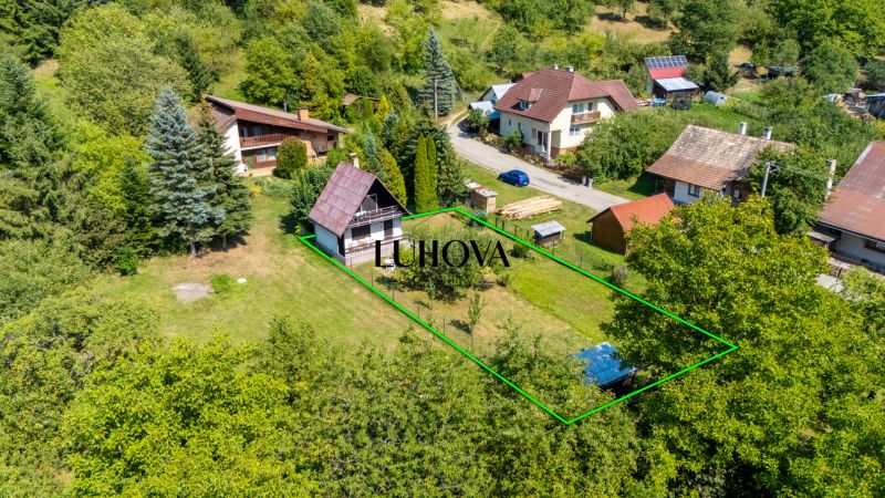 The house on Dubkova Street in Lazy pod Makytou is surrounded by greenery and other houses.