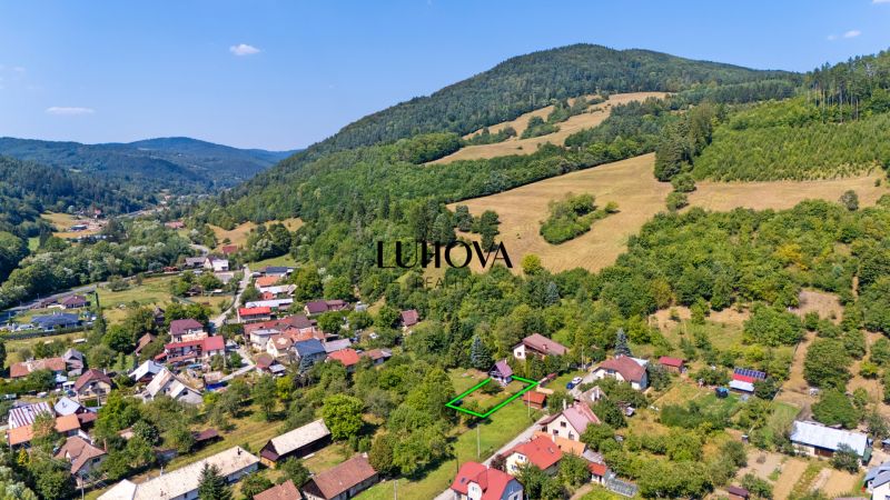 Aerial view of Lazy pod Makytou, Dubková, surrounded by picturesque nature and hills.