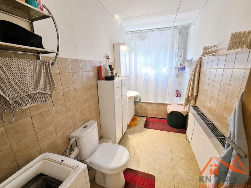 Bathroom with a bathtub and toilet in a family house.