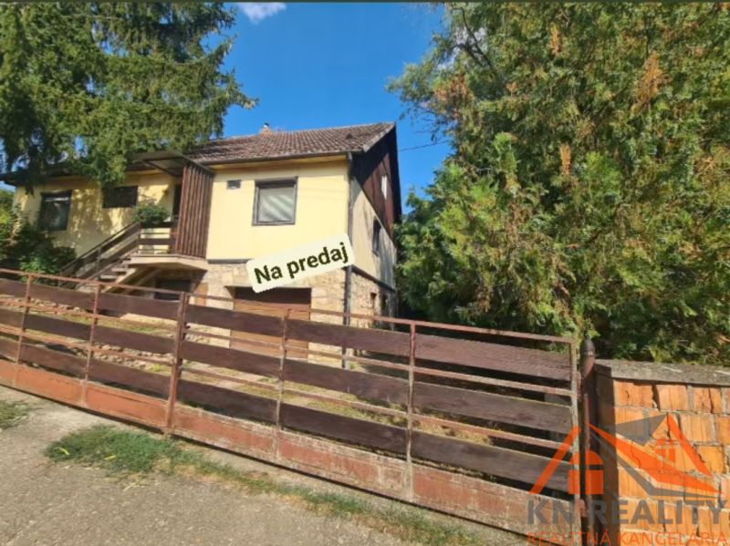 A family house in Svodín surrounded by greenery, with a stone terrace, for sale.