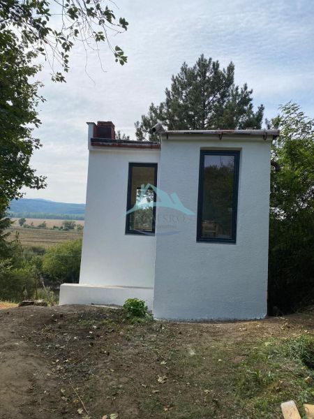 A small cottage in Šahy, surrounded by trees and beautiful nature.