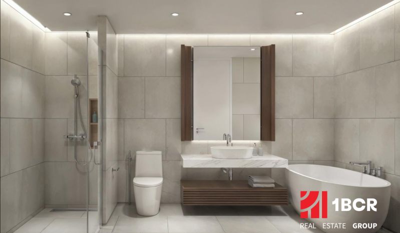 A bathroom in a 2-room apartment with a bathtub, shower, and modern sink.