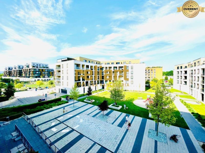 A seat with modern buildings and greenery in Bratislava-Petržalka on Žltá Street.