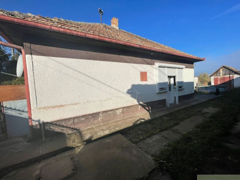 A family house in Tvrdošovce with a protruding veranda and a sloped roof.