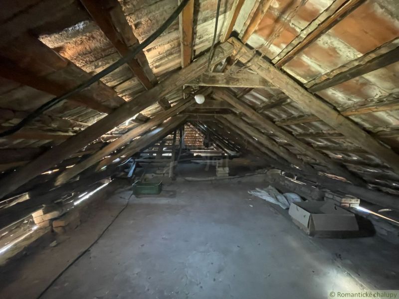 Attic in a family house with wooden beams and roof structure.