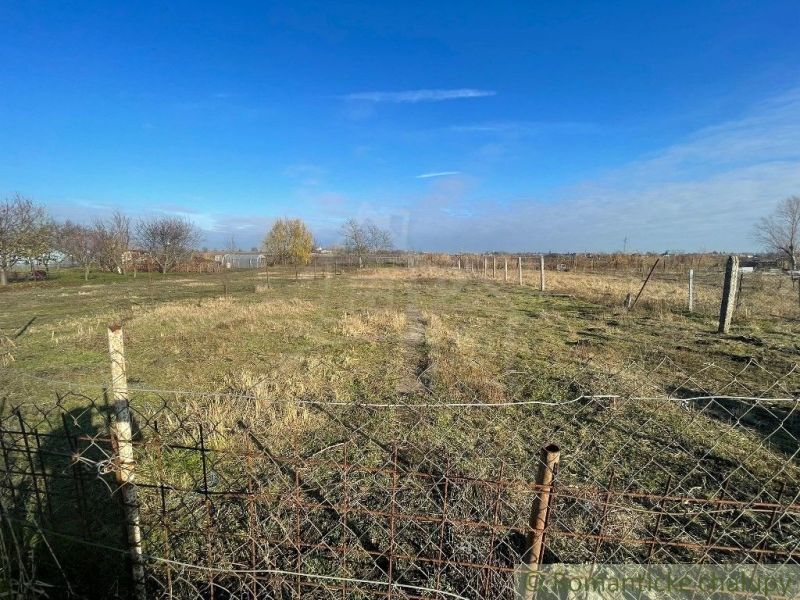 A vast plot of land fenced with a wire fence around Tvrdošovce.