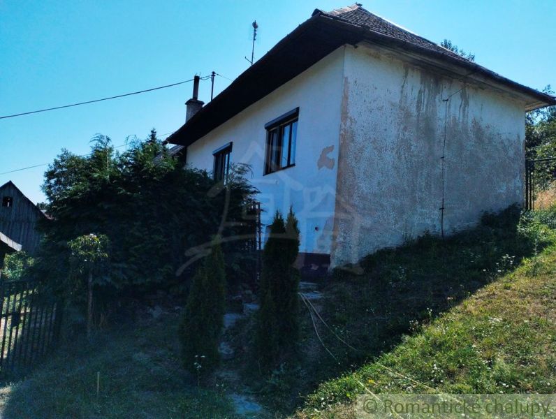 A family house in Stará Turá surrounded by greenery and hilly terrain.