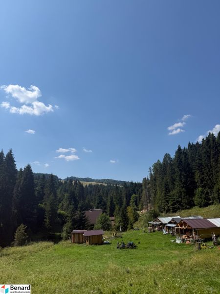 Recreational plots in Litmanová surrounded by forests and blue skies.