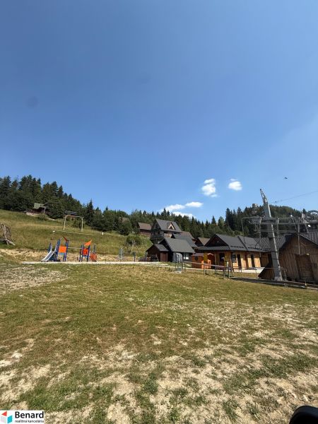 Recreational plots in Litmanová with a children's playground and surrounding forests.