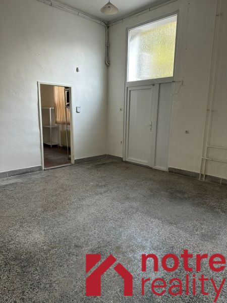 An office interior with white walls and a floor with a concrete effect decor.