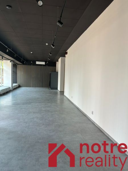 Spacious offices with wood-decor flooring, white walls, elegant lighting.