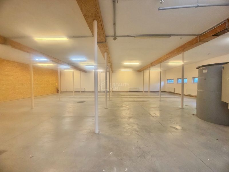 Wide commercial spaces with concrete floors and columns, suitable for business.