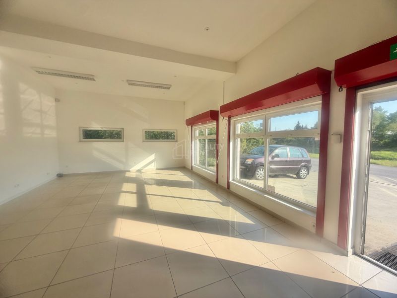 Commercial spaces with large windows, tiles, and white walls.