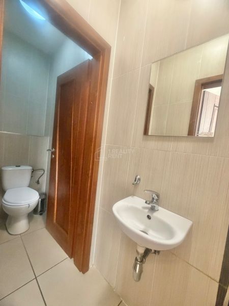 A restroom with a sink and a mirror in commercial premises.