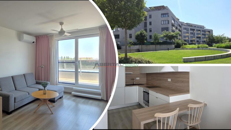Living room with a sofa and a balcony, kitchen, and exterior of the building with greenery.
