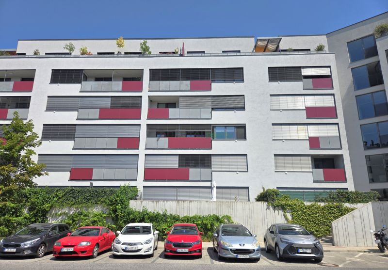 Apartment building on Malokrasňanská Street in Bratislava - Rača with parked cars in front.