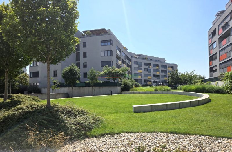 Apartment buildings with modern architecture and greenery on Malokrasňanská Street in Bratislava - Rača.