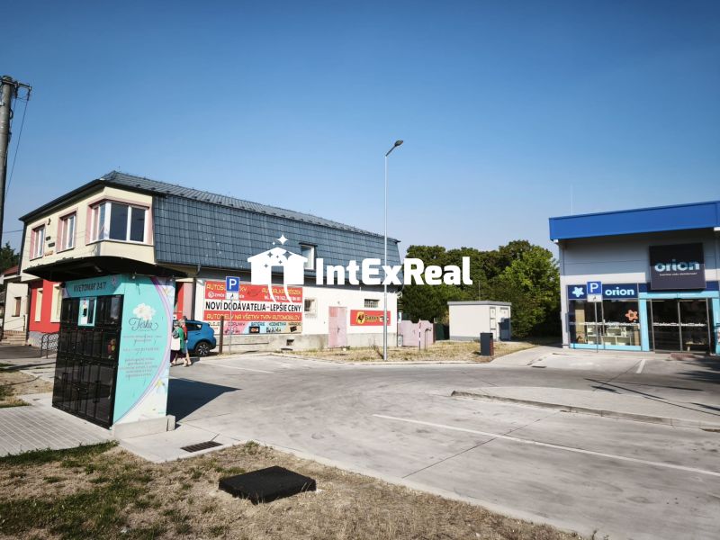 Commercial premises on SNP Street in Šaľa with parking lot and advertising signs.