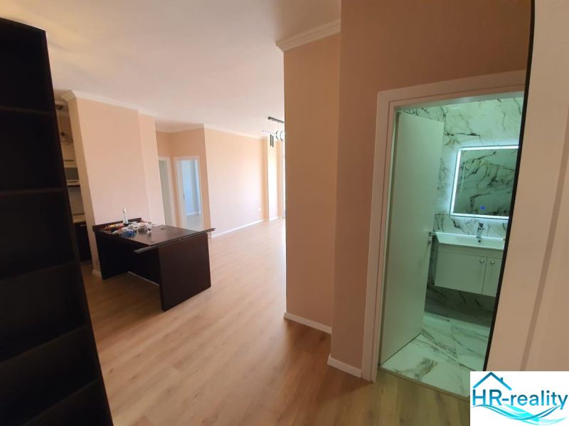 Recreational apartment with wood-patterned flooring and a modern bathroom.