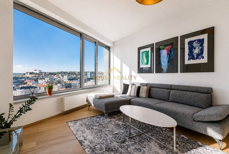 Living room in a three-room apartment with a wooden decor floor and a view of the city.