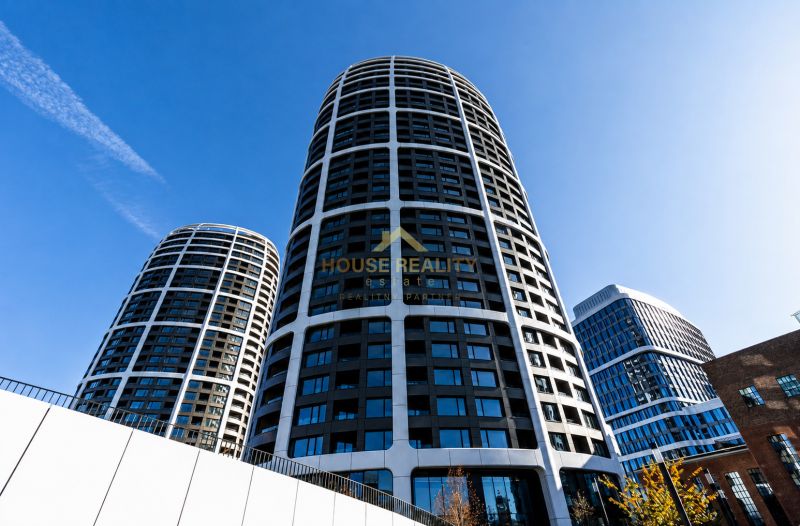 High-rise buildings in Bratislava - Old Town on Továrenská Street, with a blue sky.