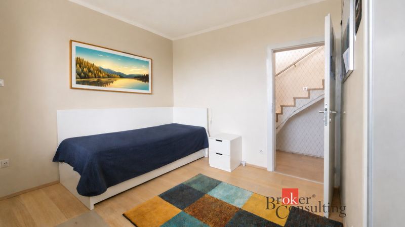 Children's room in a family house with simple furniture and a wooden decor floor.