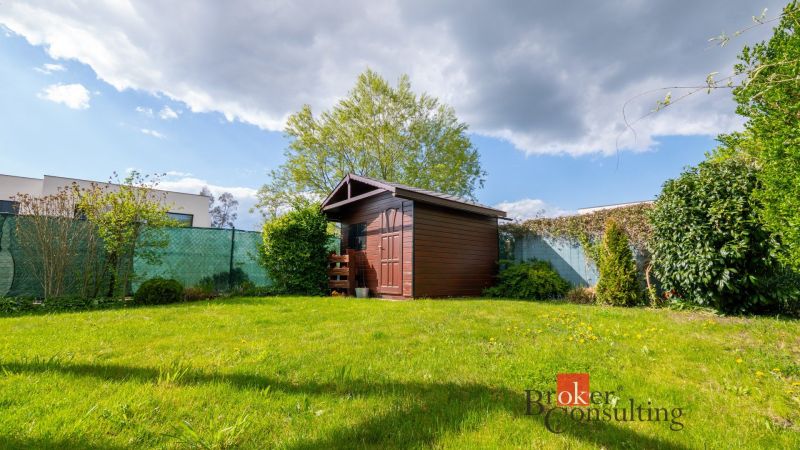 The garden of a family house on Kapsohradská in Bratislava-Záhorská Bystrica with a wooden shelter.