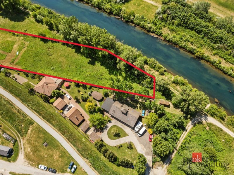 Aerial view of Recreational plots by the river in Hamuliakovo, bordered by a red line.