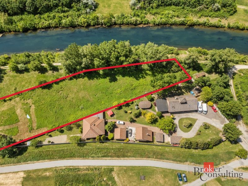 Aerial view of recreational plots in Hamuliakovo by the river, surrounded by greenery.