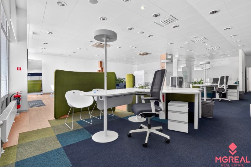 Office commercial spaces with open seating, carpet tiles, and office desks.