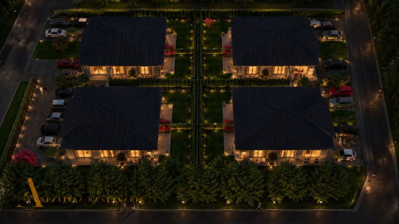 Evening view of illuminated houses with beautiful gardens in Dunajský Klátov (Plots - housing).